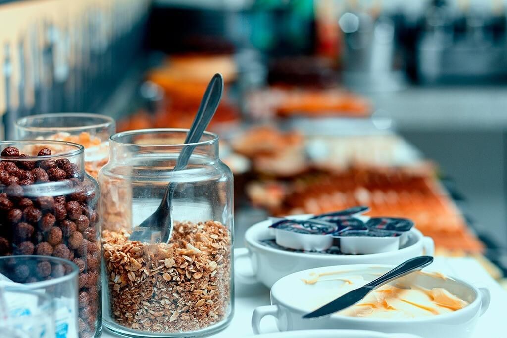 A breakfast buffet with various food items and containers.