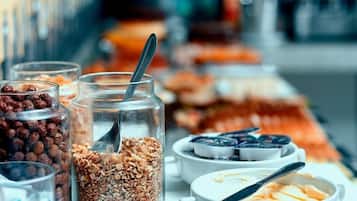 A breakfast buffet with various food items and containers.