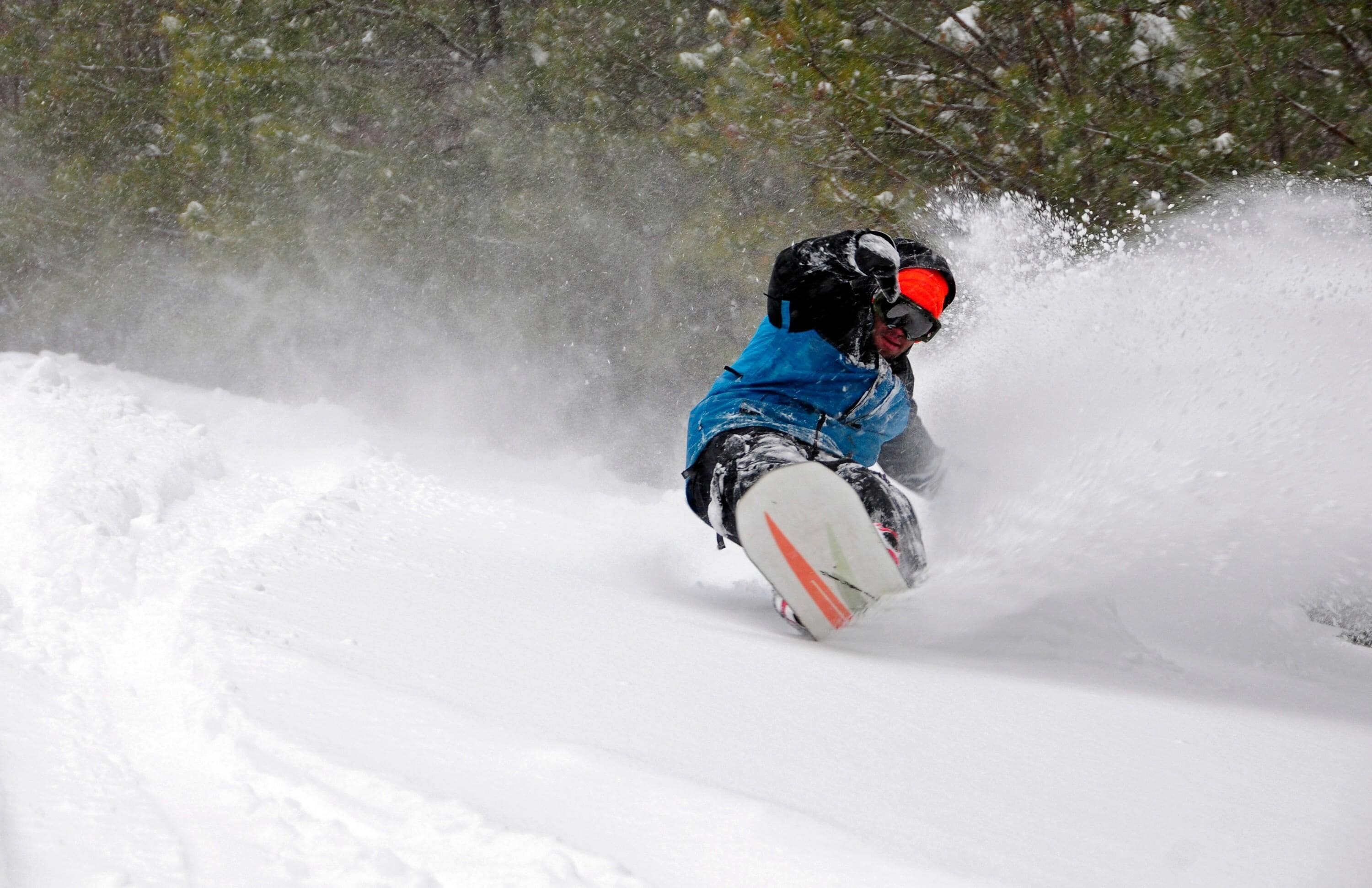 A person snowboarding down a snowy slope.