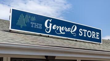 A sign for 'The General Store' with a logo of three trees.