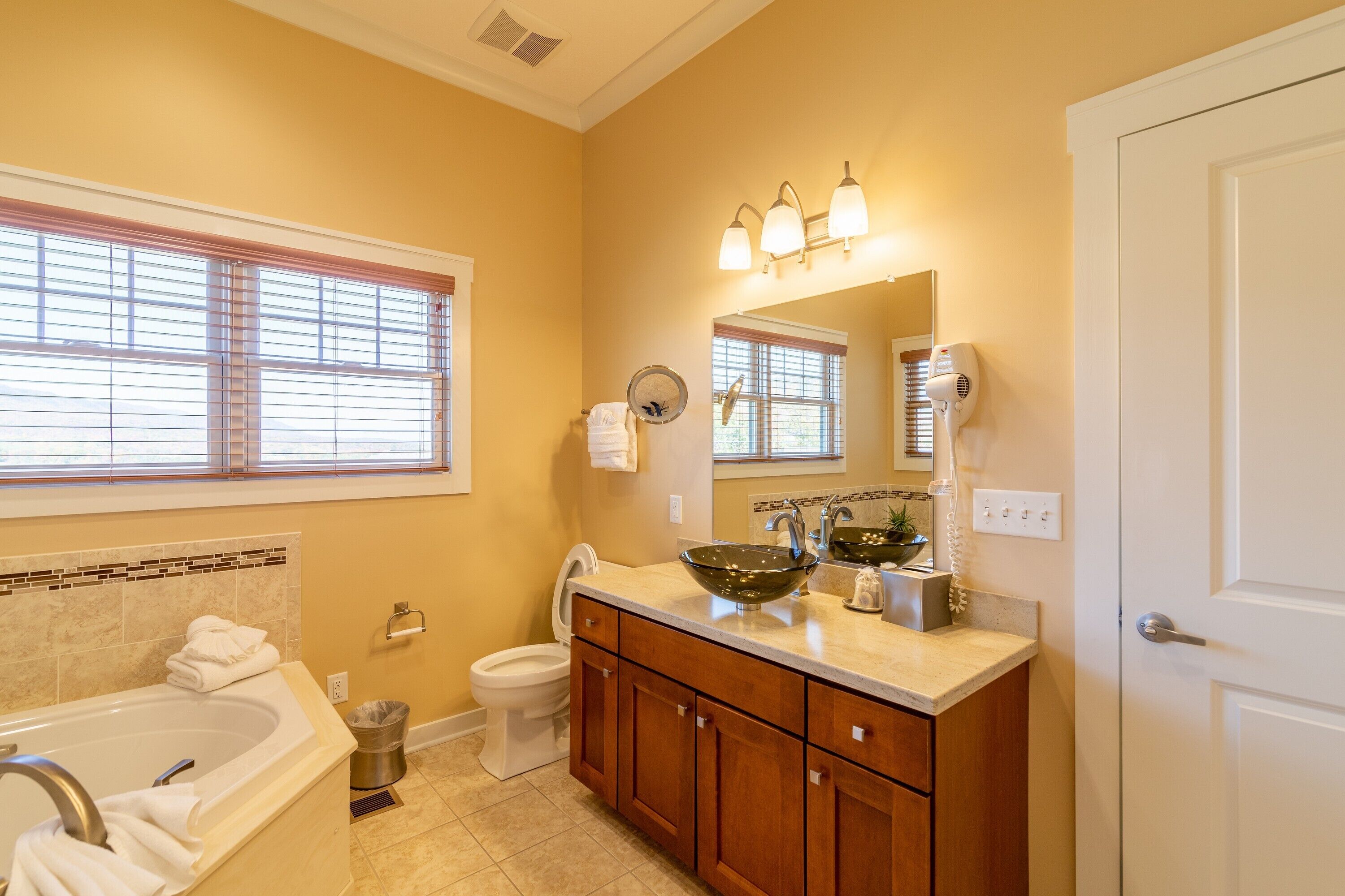 A bathroom with a bathtub, sink, and toilet.