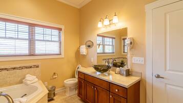 A bathroom with a bathtub, sink, and toilet.