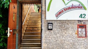 A wooden staircase leading to a stone-walled entrance with a sign reading "Casa Babolonia 42". - Casa Babilônia (Rio de Janeiro)
