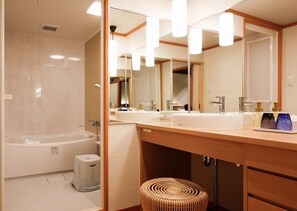 Relax in a spacious bathroom with a bathtub and double sink vanity.