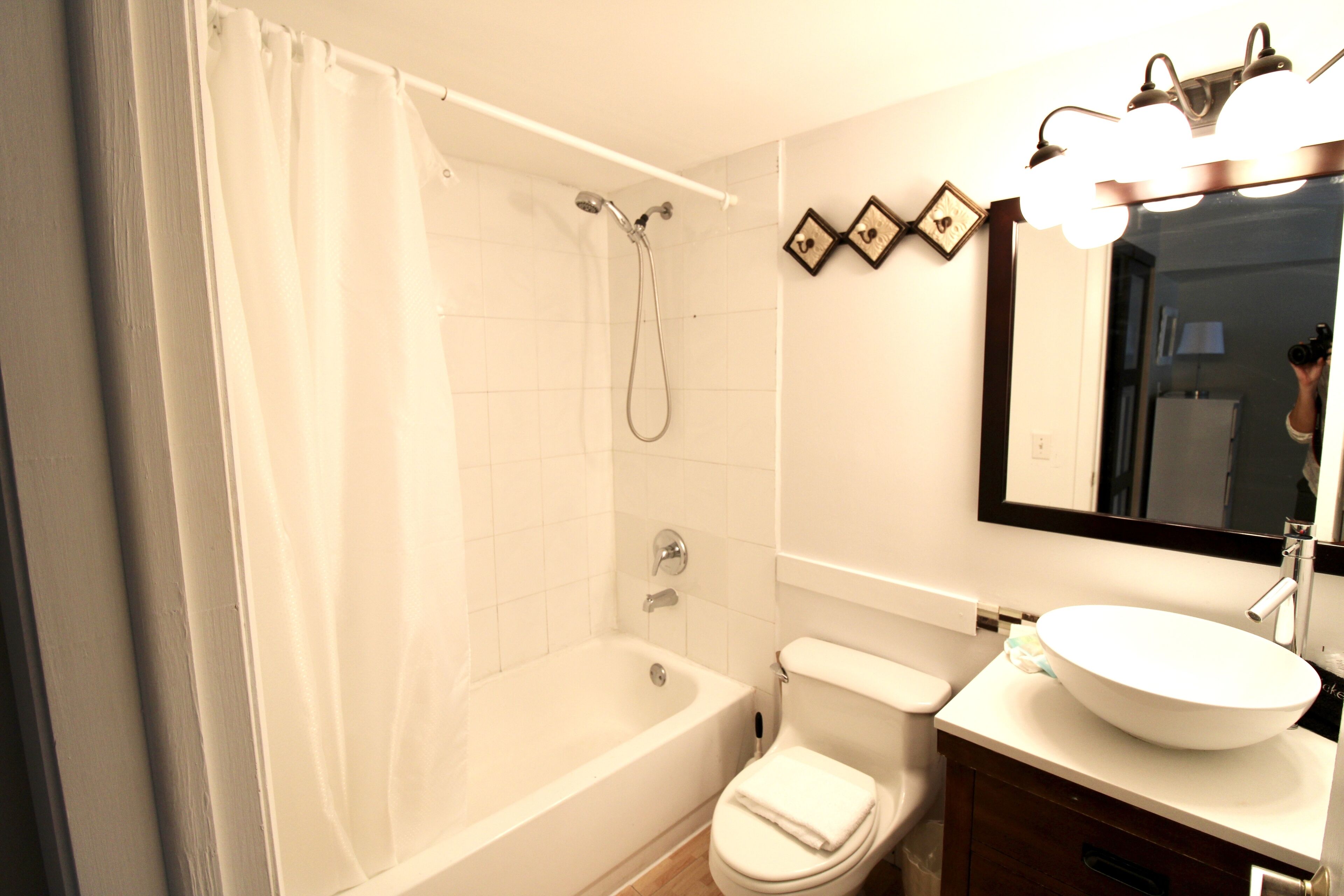 A bathroom with a bathtub, toilet, and sink.