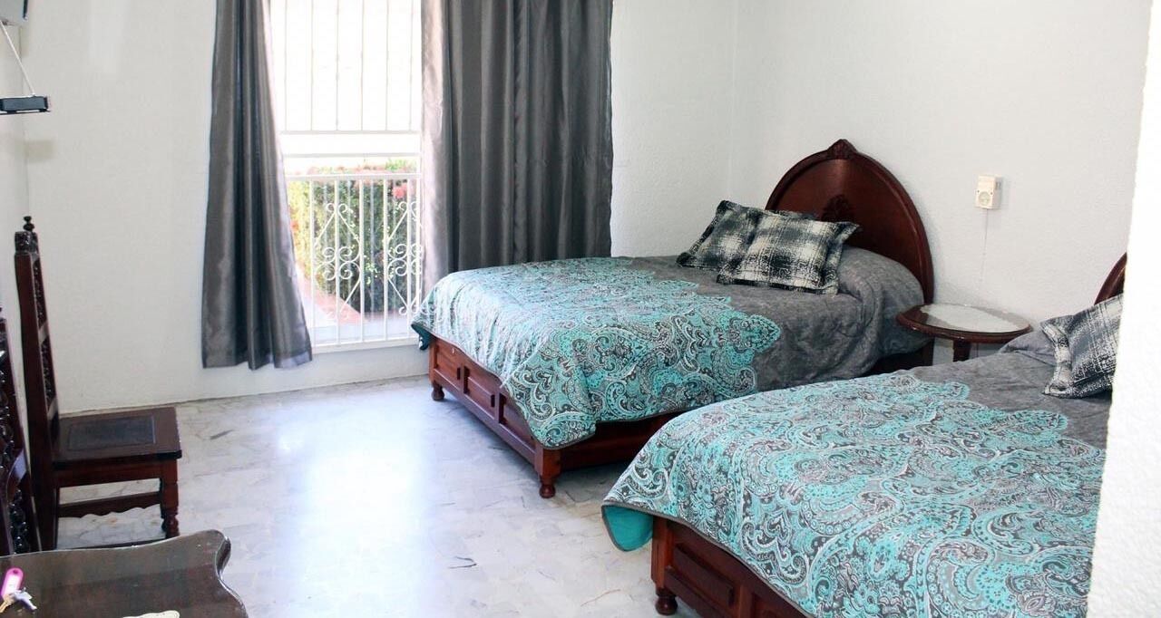 Quarto quádruplo standard | Cortinas blackout, ferros/tábuas de passar roupa, Wi-Fi de cortesia