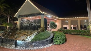 A building with a waterfall feature labeled "Falling Waters" and a paved entrance area. - Resort-style condo - close to beaches and downtown Naples. (Naples)