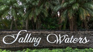 A stone wall with the text "Falling Waters" in white cursive letters. - Resort-style condo - close to beaches and downtown Naples. (Naples)