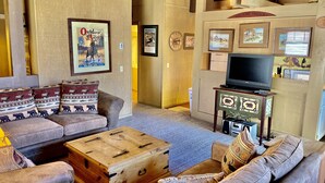 A cozy living room with a sofa set, a wooden chest, and a television. - Mountain Retreat.                  (Mammoth Lakes)