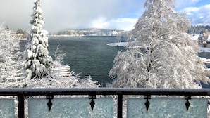 A snow-covered landscape with a lake, trees, and a distant shoreline. - Lake Arrowhead Resort and Spa (Lake Arrowhead)