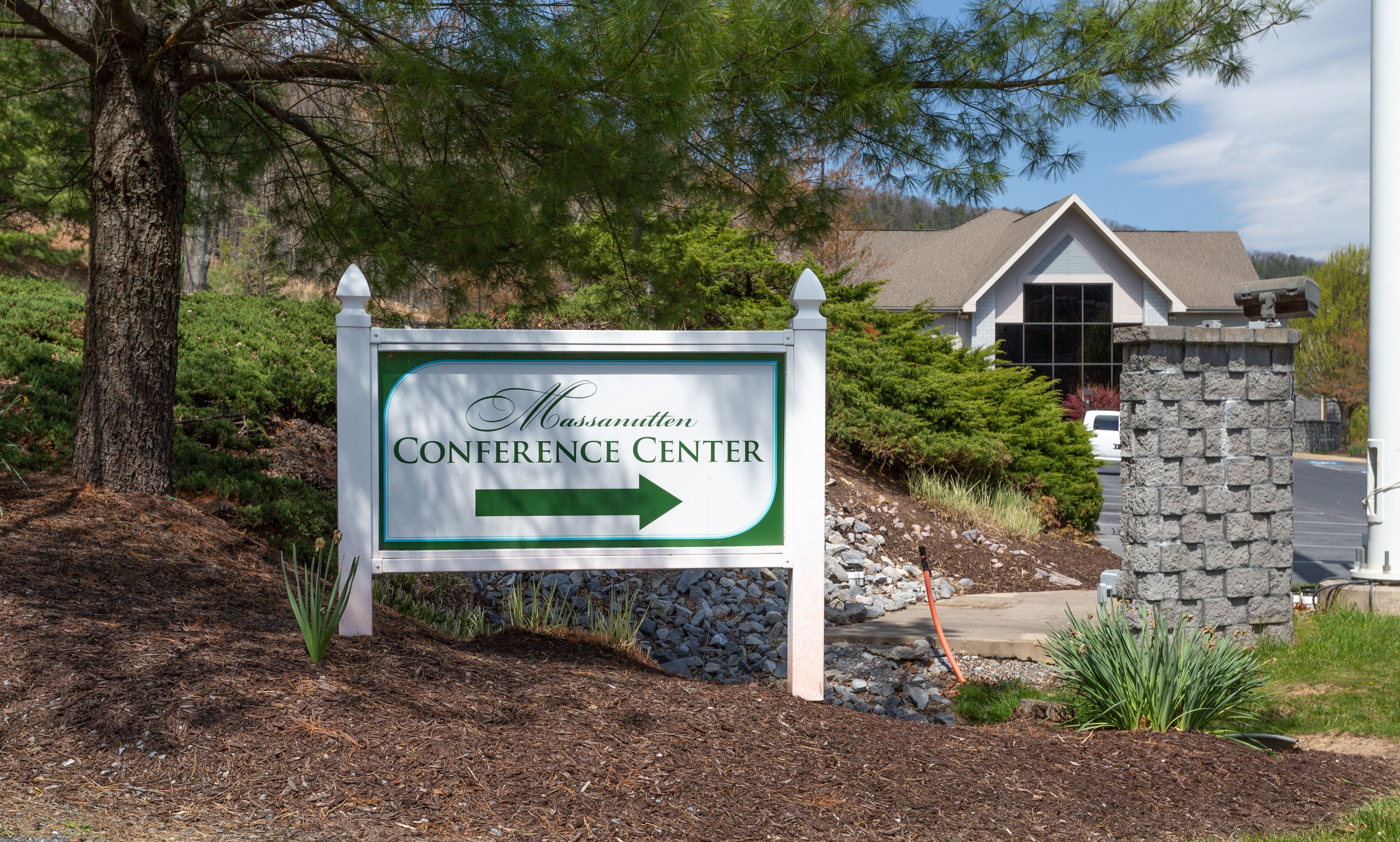 A sign for the Massanutten Conference Center with a directional arrow.