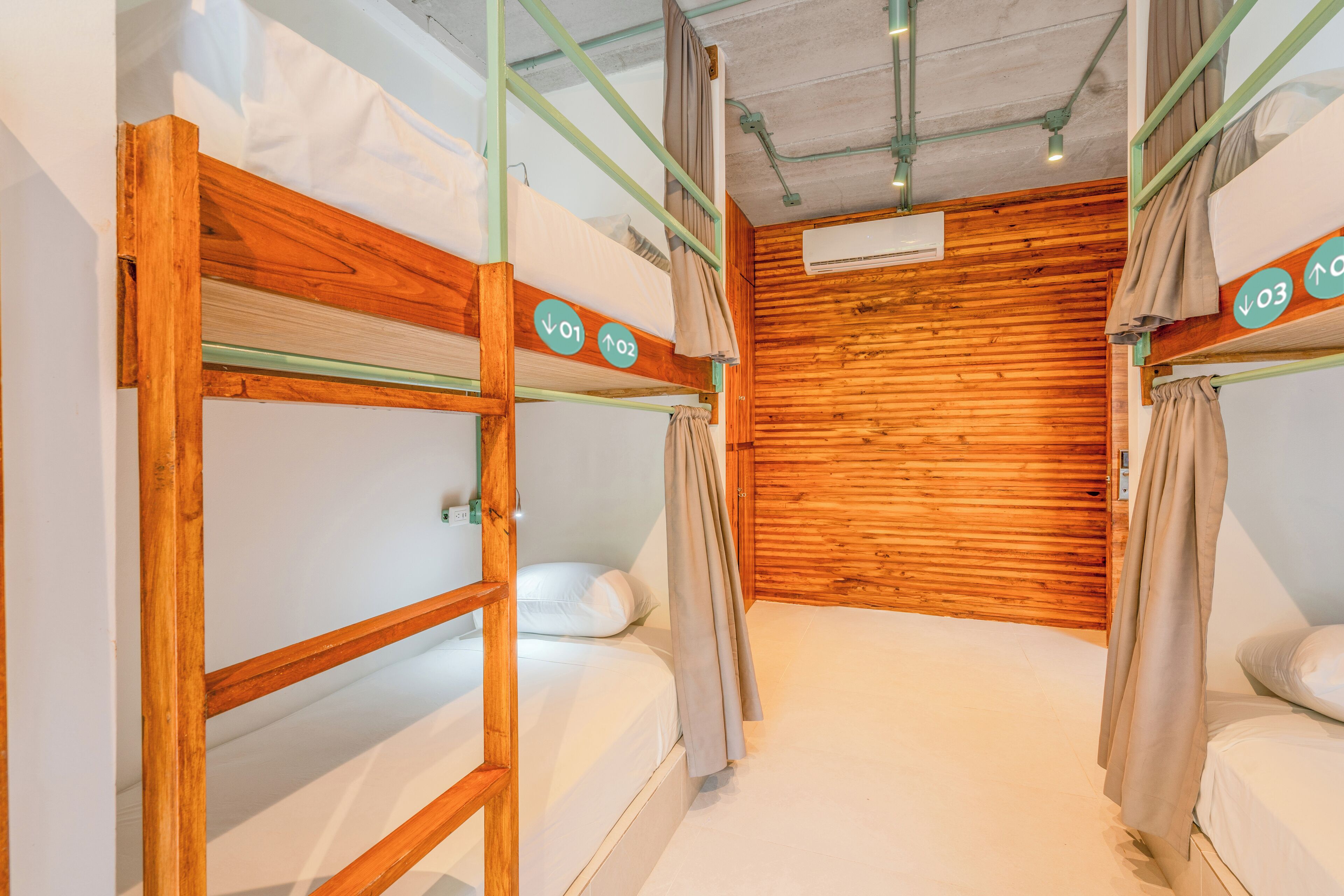 A bunk bed room with wooden walls and a ceiling fan.
