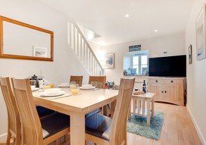 Enjoy meals in this dining area with a table for four and a large flat-screen TV.
