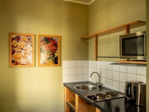 Fridge, microwave, cookware/dishes/utensils, dining tables