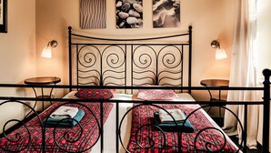 A hotel room with a bed, two bedside tables, and a wall with three framed pictures. - Kipling by Interhome (Marianske Lazne)
