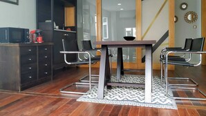 A modern dining area with a table, chairs, and a coffee machine. - ÁgoraLux, The door of Ourense. (Ourense)