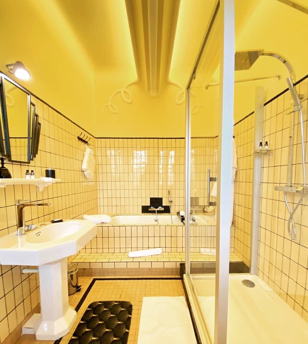 A bathroom with a bathtub, a shower, and a sink.
