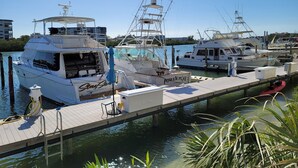 A marina with several boats docked at wooden piers.