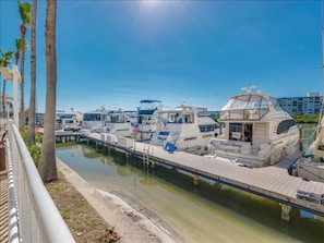 Guests can enjoy a tranquil waterfront setting with access to a marina featuring a variety of boats.