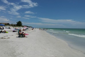 Relax on the sandy shore with comfortable sun loungers and beach umbrellas.