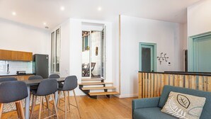 A modern apartment with a kitchen, dining area, and living room.