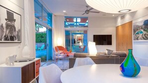 A modern interior with a white dining table, colorful chairs, and a blue vase. - Glass and Steel House 2012 (Palm Springs)