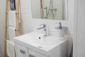 Regadera, secadora de cabello, toallas, jabón 