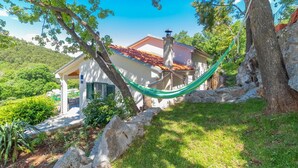 A house with a tiled roof, a chimney, and a hammock tied between trees. - Amazing home in Klenovica (Klenovica)
