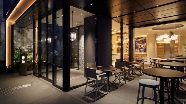 An indoor dining area with tables and chairs, glass walls, and modern lighting fixtures. - Agora Tokyo Ginza (Tokyo)