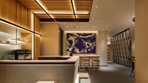 A modern interior with a kitchen area, a dining space, and a large abstract painting on the wall. - Agora Tokyo Ginza (Tokyo)