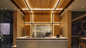 A modern kitchen with a central island, wooden cabinetry, and built-in appliances. - Agora Tokyo Ginza (Tokyo)