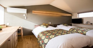 Cozy sleeping area with a single bed, desk, and TV for a comfortable stay.