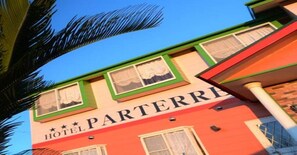 Hotel Parterre features a simple, functional design with a red facade and green trim.