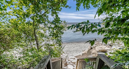 Quaint lakefront cottage w/ private hot tub, firepit, & beautiful sunset views