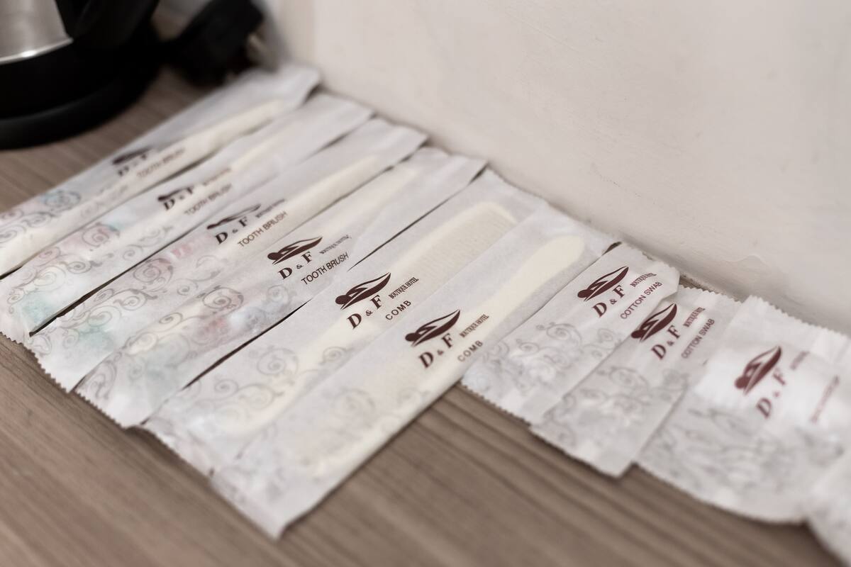 A series of D&F toothbrushes laid out on a wooden surface.