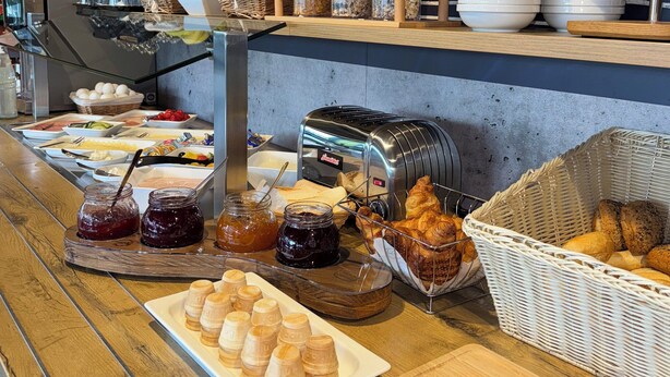 A breakfast buffet with various food items and condiments. - Hotel Stay Inn Köln Leverkusen City (Leverkusen)