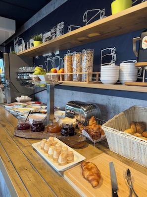 A breakfast buffet with various food items and condiments. - Hotel Stay Inn Köln Leverkusen City (Leverkusen)