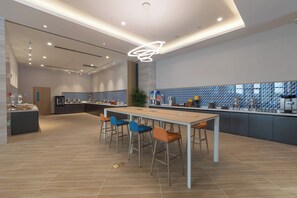 A modern kitchen with a central island, bar stools, and a patterned backsplash. - Holiday Inn Express Kaifeng City Center by IHG (Kaifeng)
