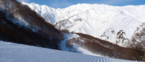 A snow-covered mountain landscape with a ski slope.