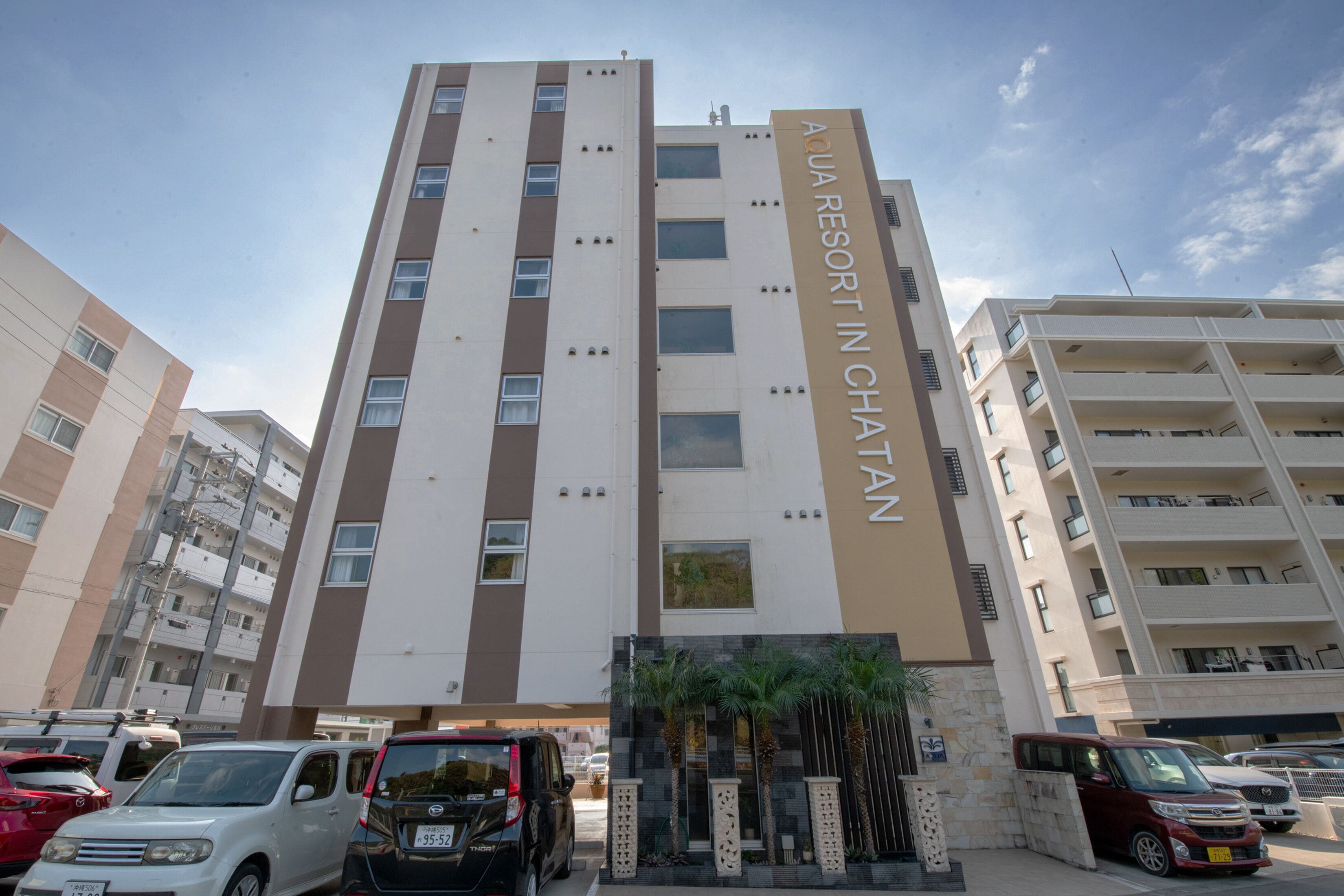 A multi-story building with a sign reading "AQUA RESORT IN CHATAN".