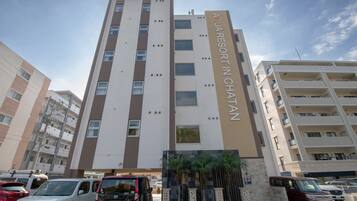 A multi-story building with a sign reading "AQUA RESORT IN CHATAN".