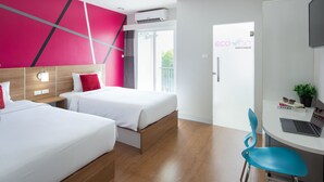 A hotel room with two beds, a desk with a laptop, a chair, and a view of the outdoors. - Eco Inn Lite Chanthaburi (Chanthaburi)