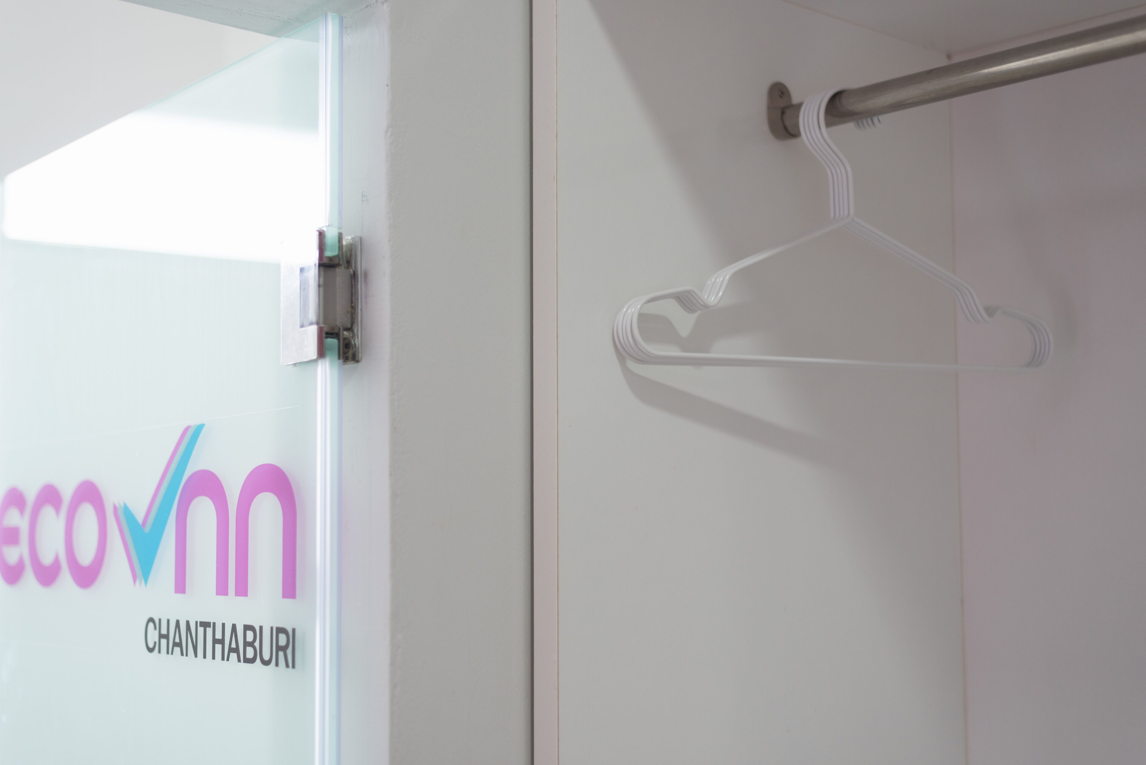 A glass door with a metal handle and a metal towel rack.