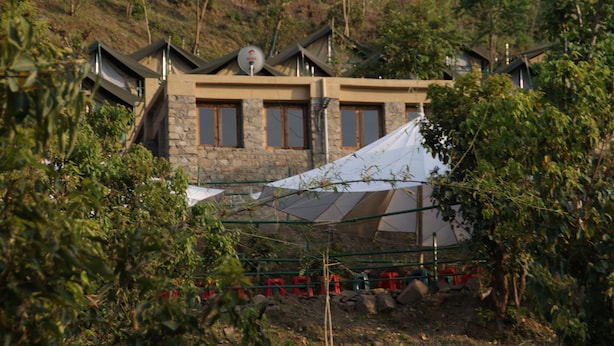 A stone building with a modern design, featuring a large tent-like structure in front. - Camp Dogadda (Lansdowne)
