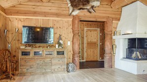 A wooden interior with a fireplace, a television, and a gnome decoration. - Cozy home in Hemsedal with kitchen (Hemsedal)