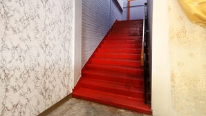 A staircase with red steps leading up to a landing. - OYO 89676 Hotel 22 (Seremban)