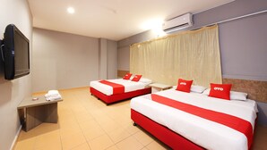A hotel room with two beds, a TV, an air conditioner, and a small desk. - OYO 89676 Hotel 22 (Seremban)