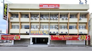 A hotel building with multiple balconies, air conditioning units, and a prominent sign indicating an opening promotion. - OYO 89676 Hotel 22 (Seremban)