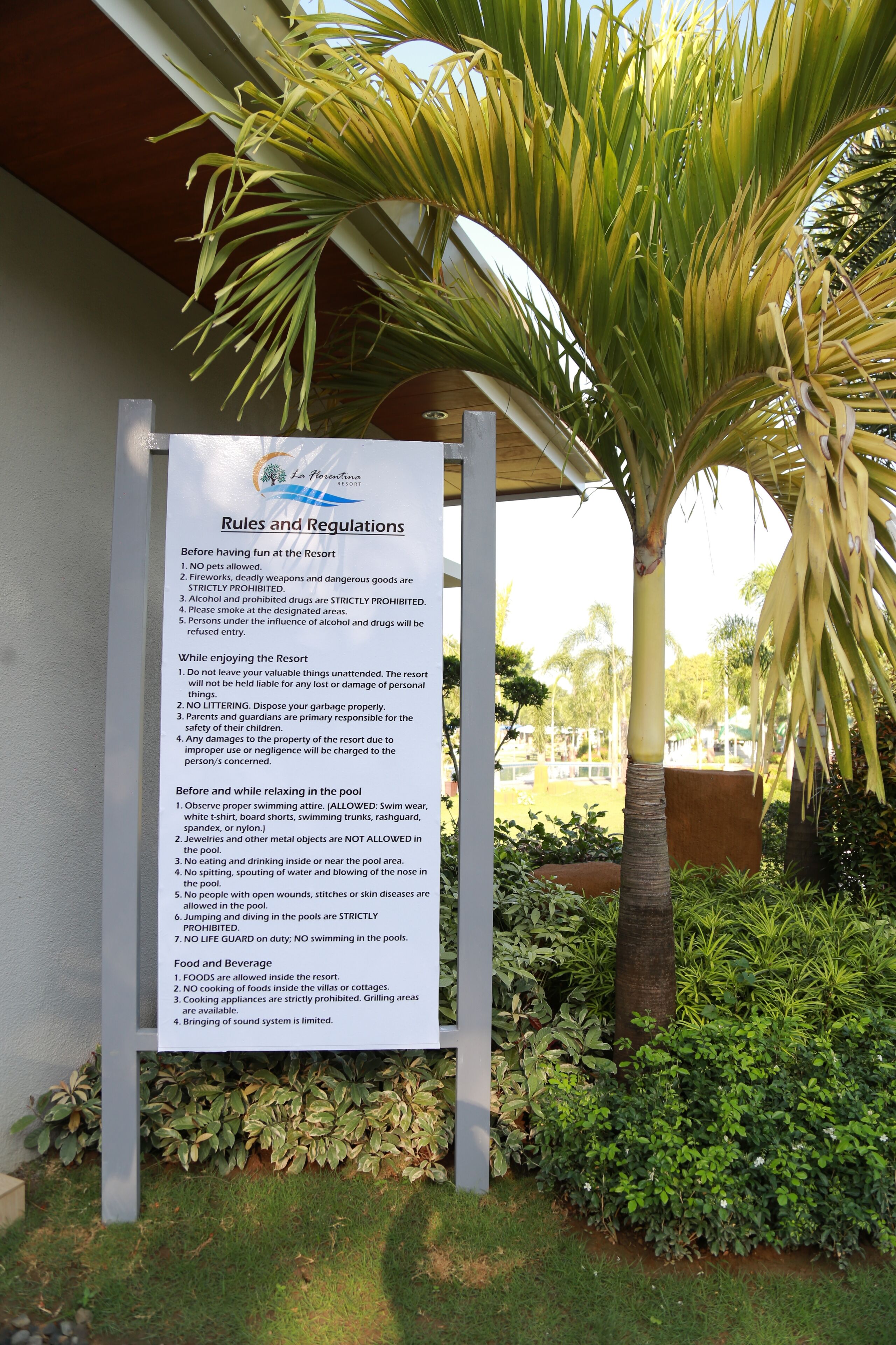 A sign listing rules and regulations for a resort, including pet policies, smoking, and pool rules.