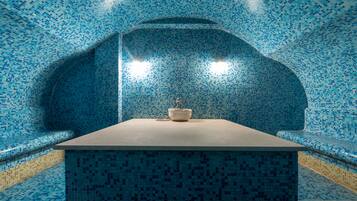 Relax by the serene pool, surrounded by a unique mosaic tile design and a central platform.